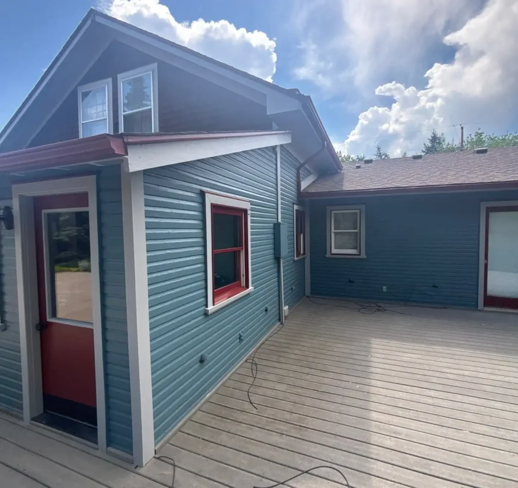 a house with a deck that has had its exterior recently repainted professionally by the A+ BBB accredited and 5-star rated company MGM Painting Co.