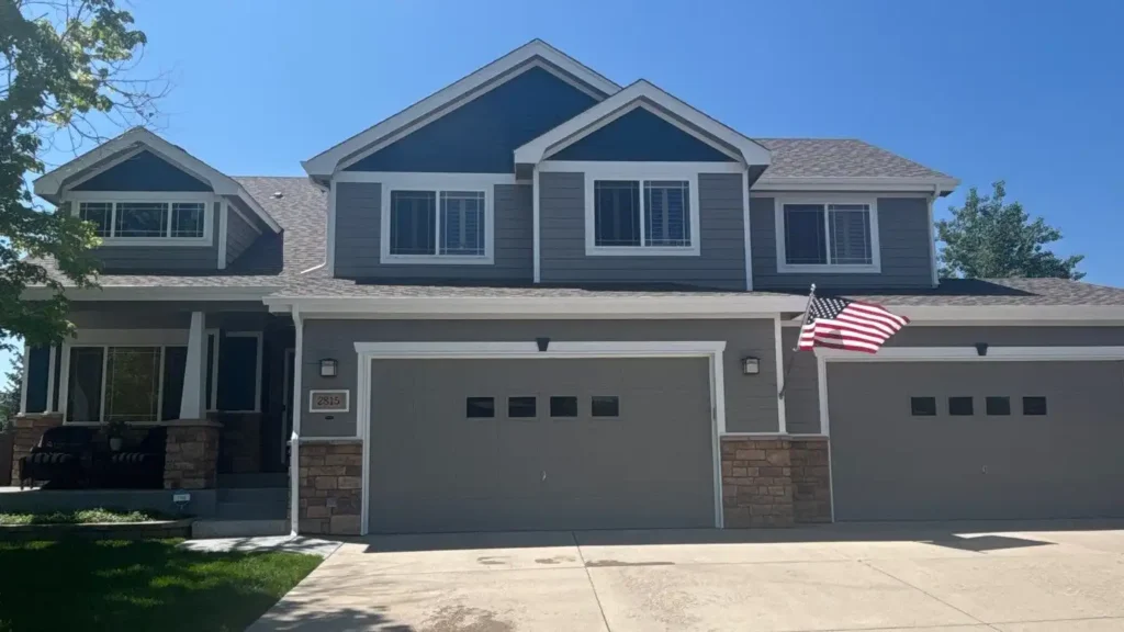 a house with a flag on the front that has had its exterior recently painted by MGM Painting Co.