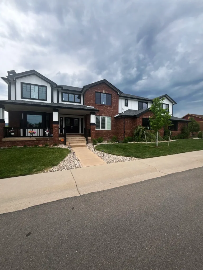 a house with a driveway and a cloudy sky