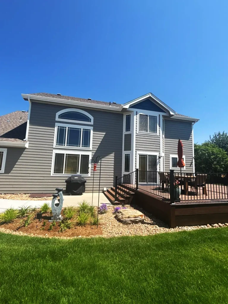 a house with a deck and a lawn