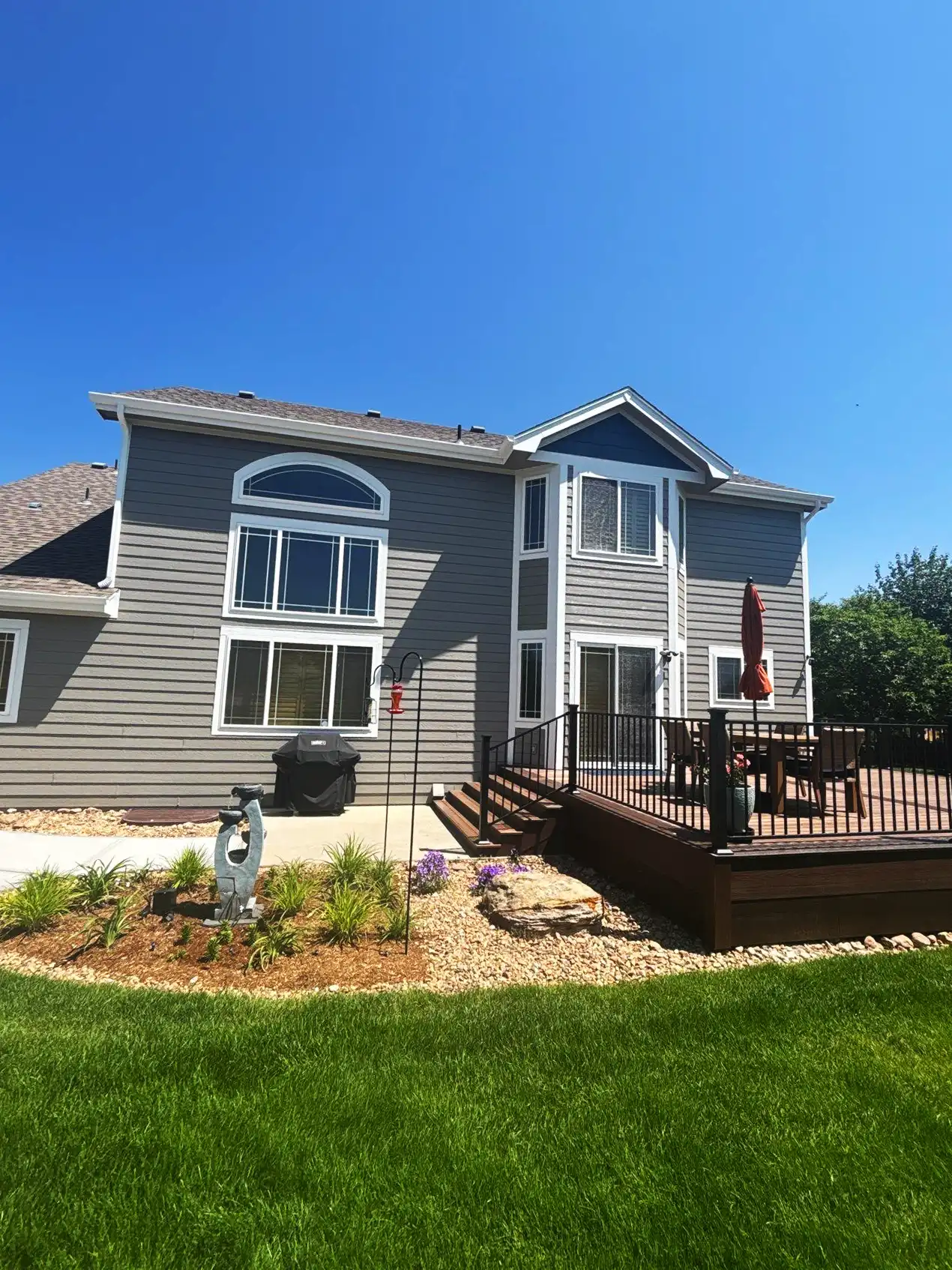 a house with a deck and a lawn