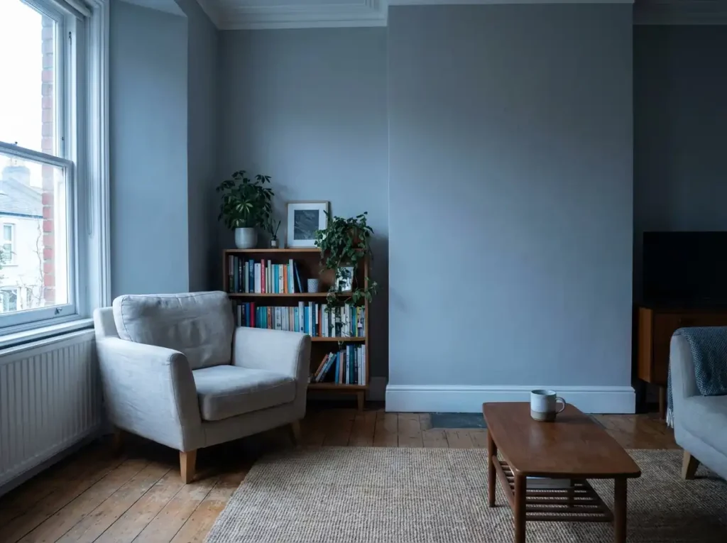 A north-facing interior room painted in a cool gray tone that appears slightly blue under indirect daylight